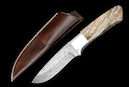 Hunting knife “Moose“ <br />Blade: damask steel, 8.3 cm<br />Knife handle: Mammoth Molar, Grade 2<br />Overall length: 19.7 cm<br />CHF 690,-